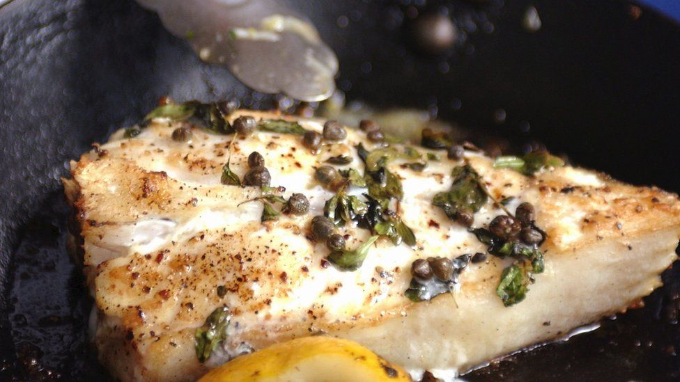 Turbot fillet being cooked in a pan