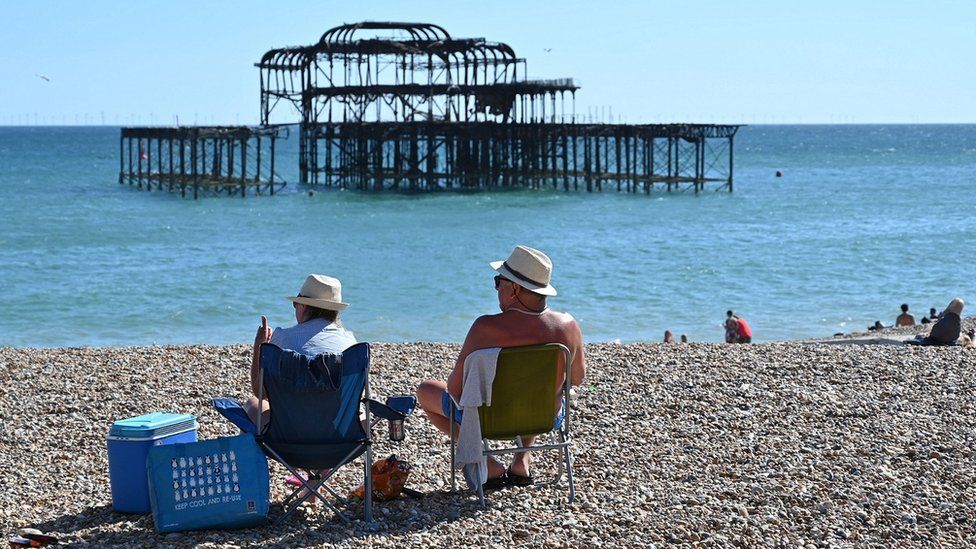 Two people relaxing on a beach in Brighton