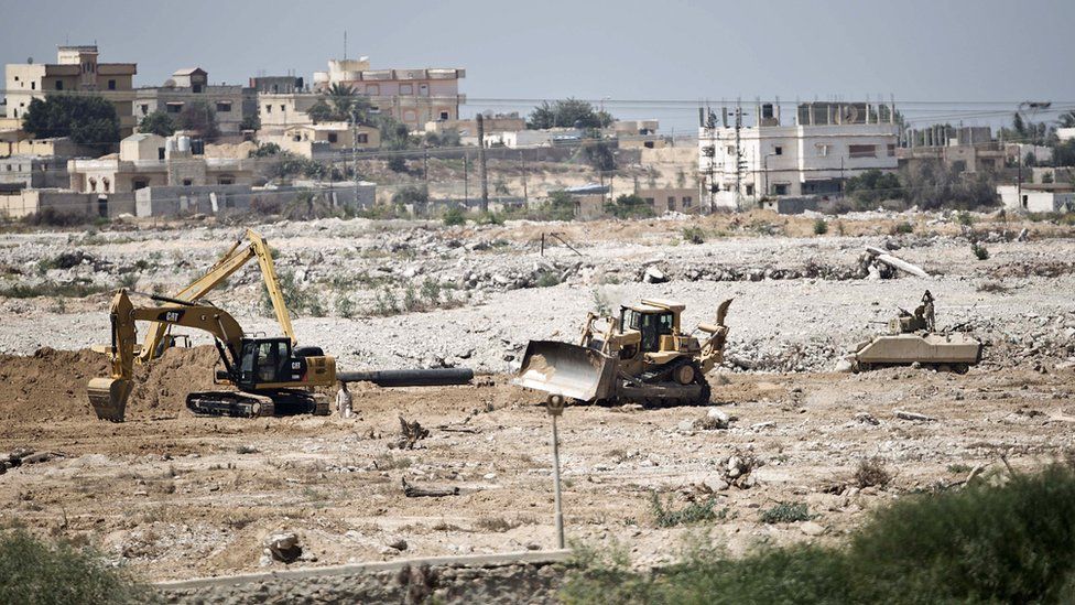 A picture taken from the southern Gaza Strip shows diggers used by the Egyptian army working on the border between Egypt and the Palestinian territory on September 1, 2015.