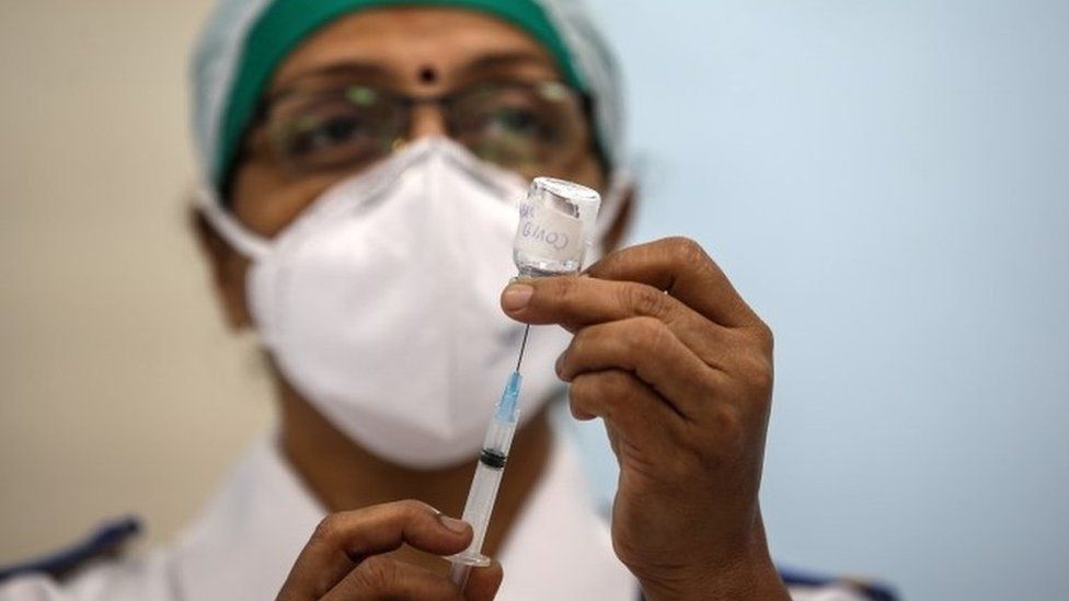 An Indian health worker mocks the vaccination process during a dry run of Covid-19 vaccination inside a Covid-19 vaccination centre at Rajawadi Hospital, in Mumbai, India, 08 January 2021.