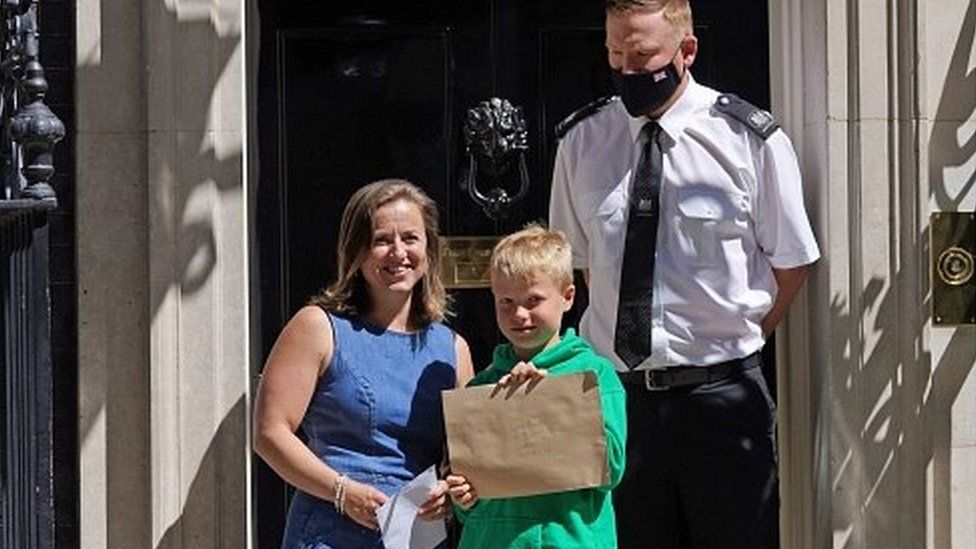 Ilmarie Braun with son, Thomas, with a letter outside number 10 Downing Street
