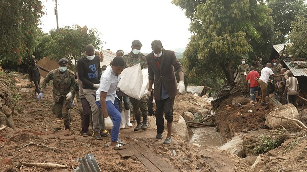 Rescue teams carrying a body