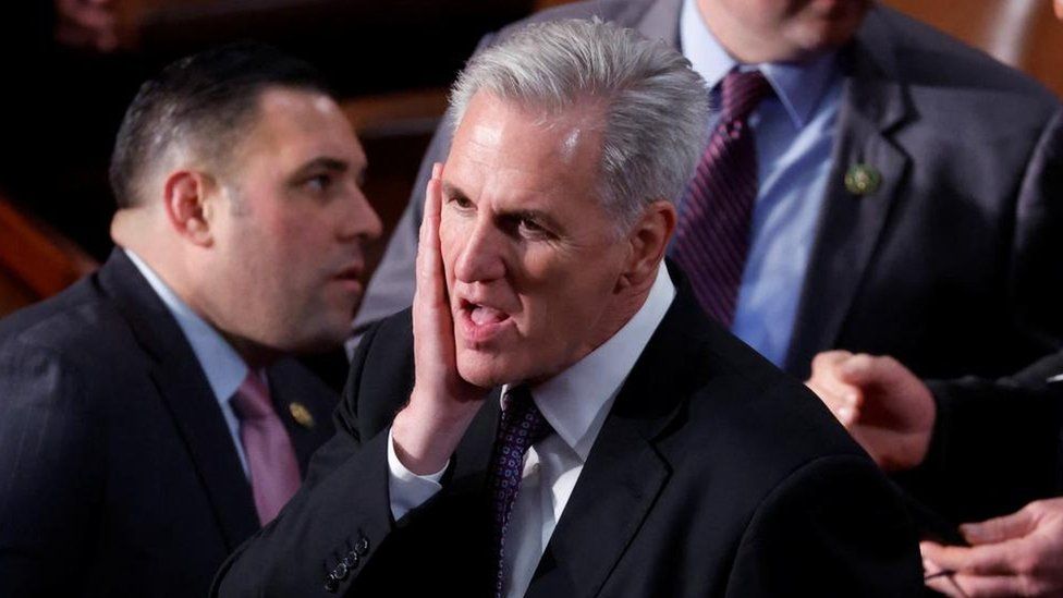 McCarthy touching his face