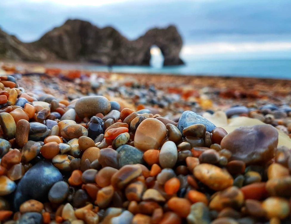 Pebbles with Durdle Door in the distance