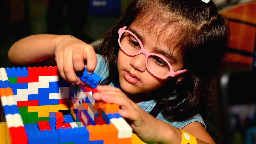 Little girl playing with Lego