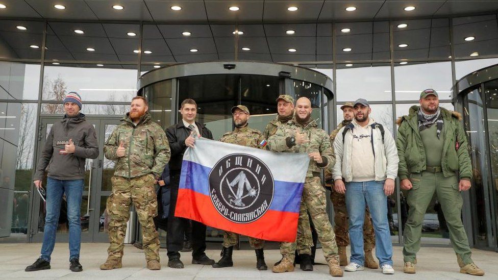 Members of Wagner Group stand outside new headquarters in St Petersburg