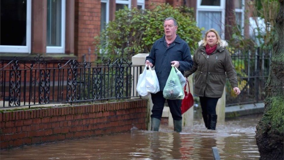 People with shopping in the flood waters