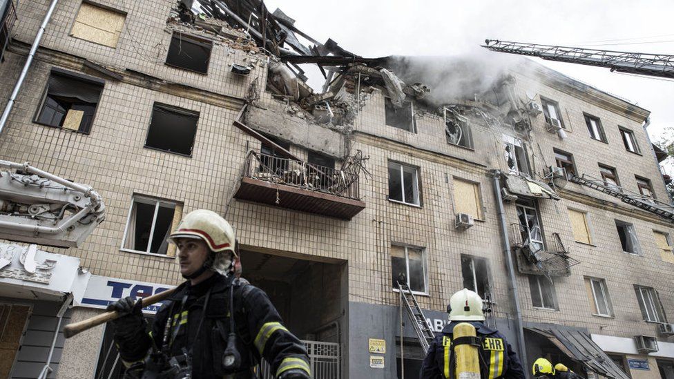 Firefighters near a damaged building in Kharkiv, 6 September