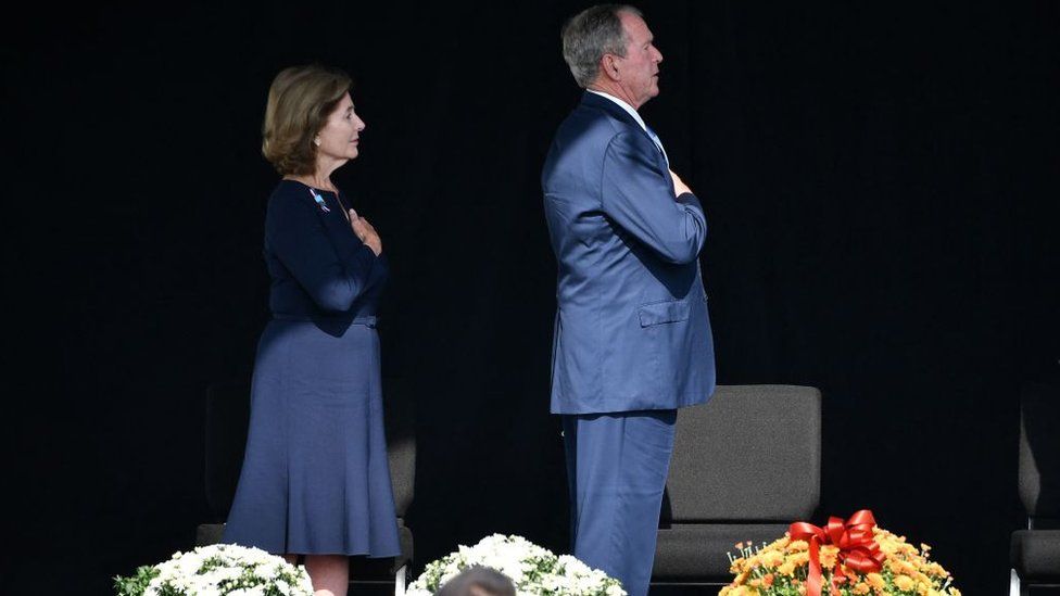 Former US President George W. Bush and former First Lady Laura Bush say a prayer as they attend a 9/11 commemoration at the Flight 93 National Memorial in Shanksville, Pennsylvania on September 11, 2021