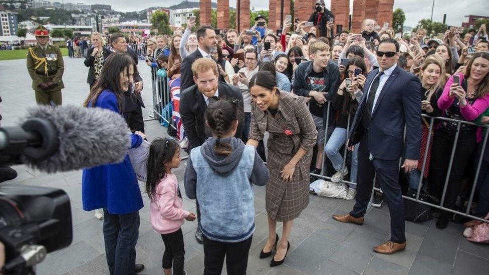 Prince Harry, Duke of Sussex and his wife Meghan, Duchess of Sussex (C-R) greet the crowd at Pukeahu National War Memorial Park in Wellington, New Zealand, 28 October 2018
