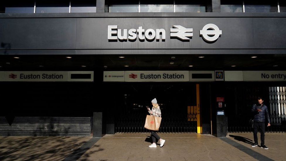 Pedestrians walk past London's Euston station