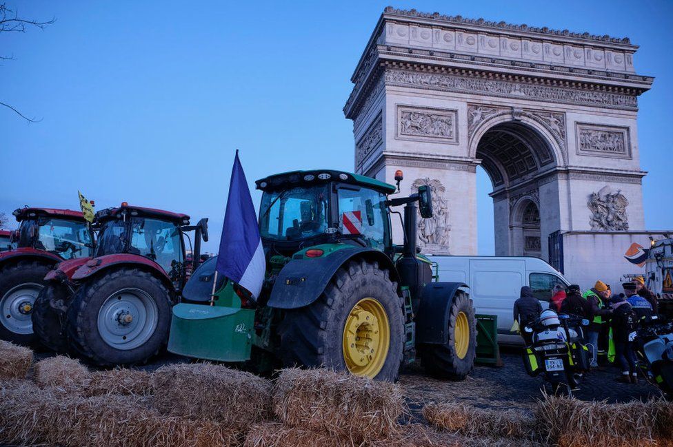 Farmers from the collective, Coordination Rurale, block the roads around the l'Arc de Triomphe, including the entry to the Champs-Élysées with hay bales and tractors on March 1, 2024 in Paris, France.