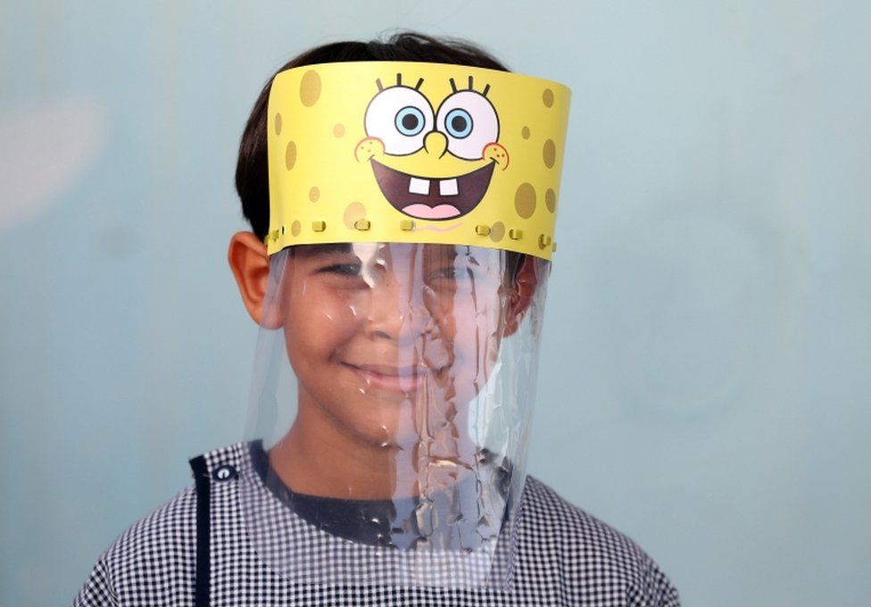 A Tunisian child wears a face shield in a school in Tunis. It features cartoon character Spongebob Squarepants.