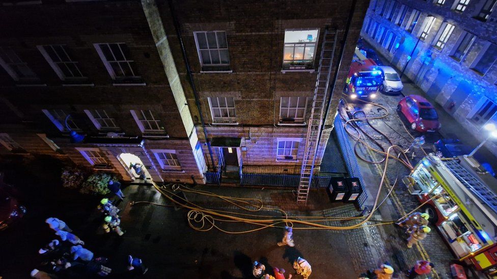 A long ladder was used to rescue two people inside the Whitechapel flat