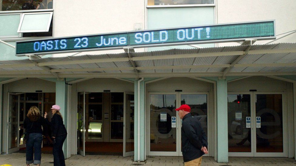 Sign saying "Oasis - sold out" outside of the lighthouse
