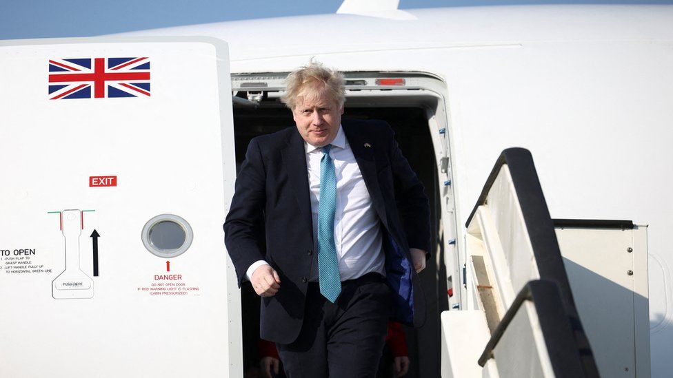Boris Johnson seen exiting a plane ahead of a Nato summit in Brussels