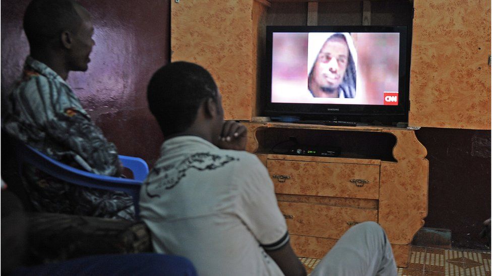 Des hommes somaliens à Mogadiscio en septembre 2014 regardent un bulletin d'information télévisé sur l'assassinat du chef d'Al-Shabab Ahmed Abdi Godane.
