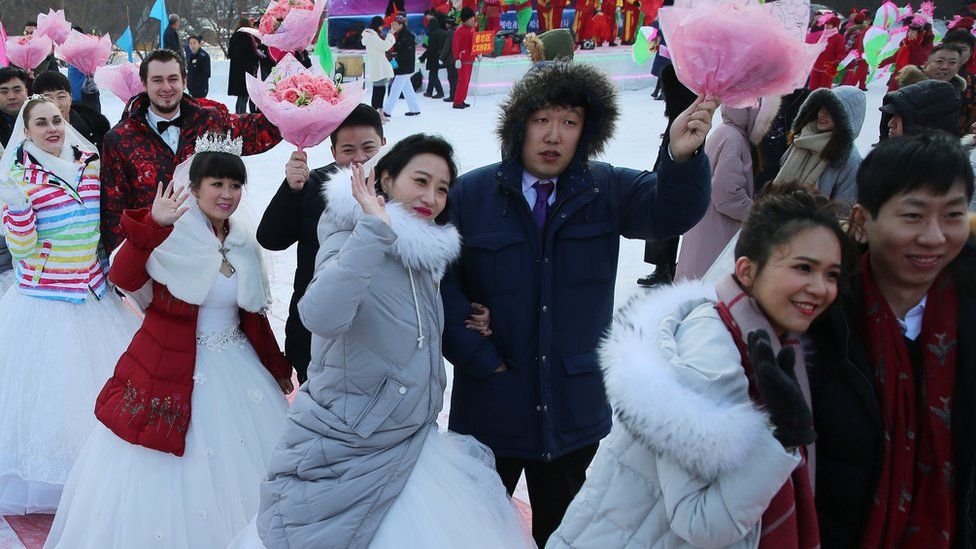 Newly wed couples attend a mass wedding ceremony at the 33rd Harbin International Ice and Snow Festival in Harbin, China's northern Heilongjiang province, 06 January 2017.
