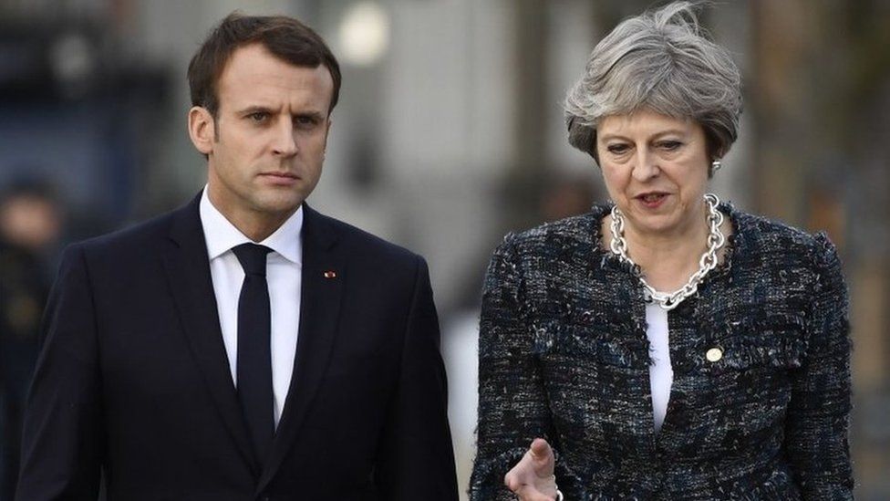 Theresa May speaking to Emmanuel Macron