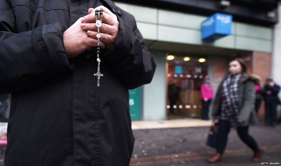 An anti-abortion activist prays with his rosary beads outside the Marie Stopes Clinic on January 12, 2016 in Belfast, Northern Ireland.
