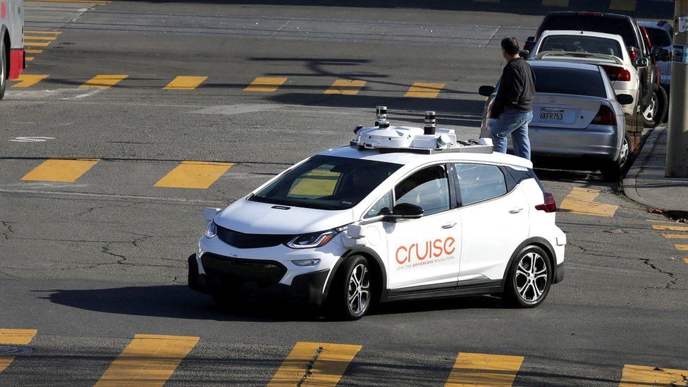 A Cruise car with cameras on its roof on the street in San Francisco