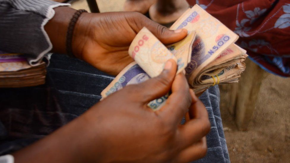 A person counting Nigerian currency, July 2020