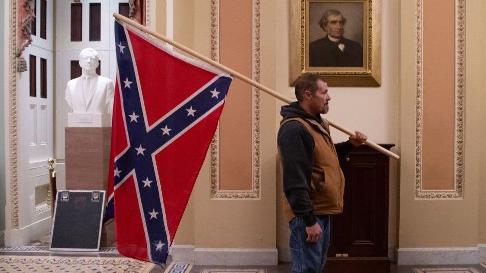 Photo of Kevin Seefried holding the Confederate flag