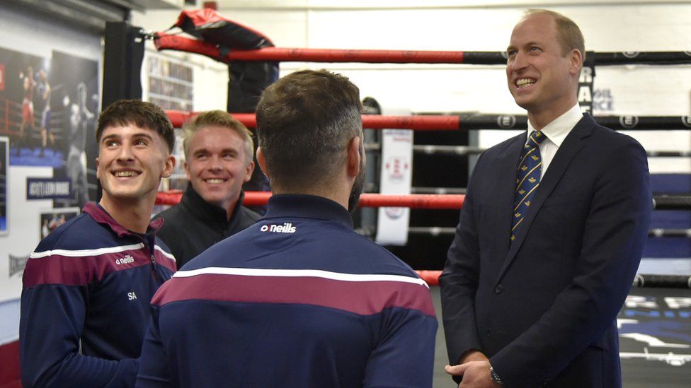 Prince William standing and talking with people from a boxing gym