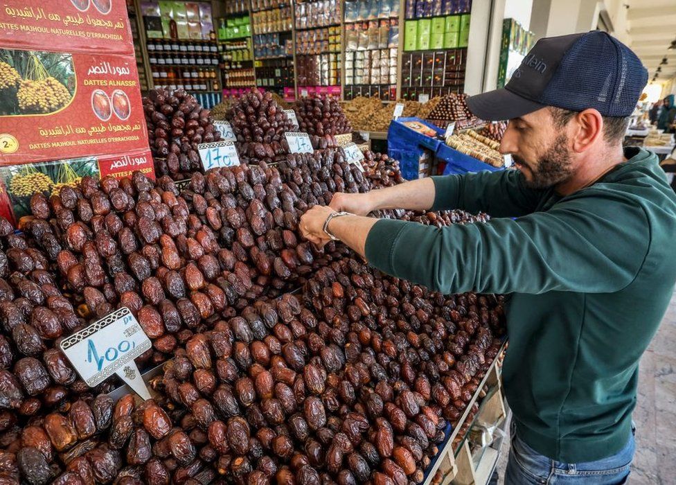 In this picture taken on April 2, 2023, a vendor arranges dates at his shop in Rabat, during the Muslim holy fasting month of Ramadan.