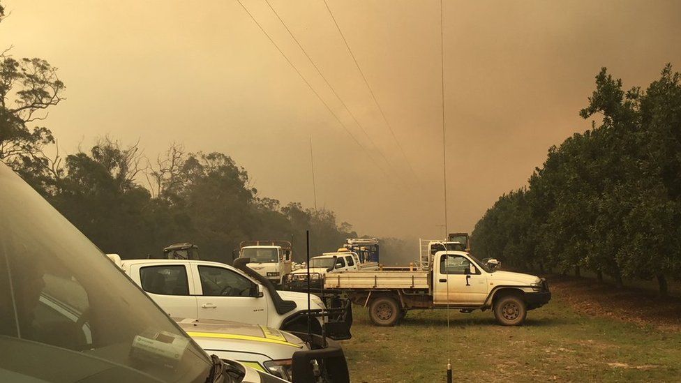 View of ambulance vehicles near a blaze in central Queensland