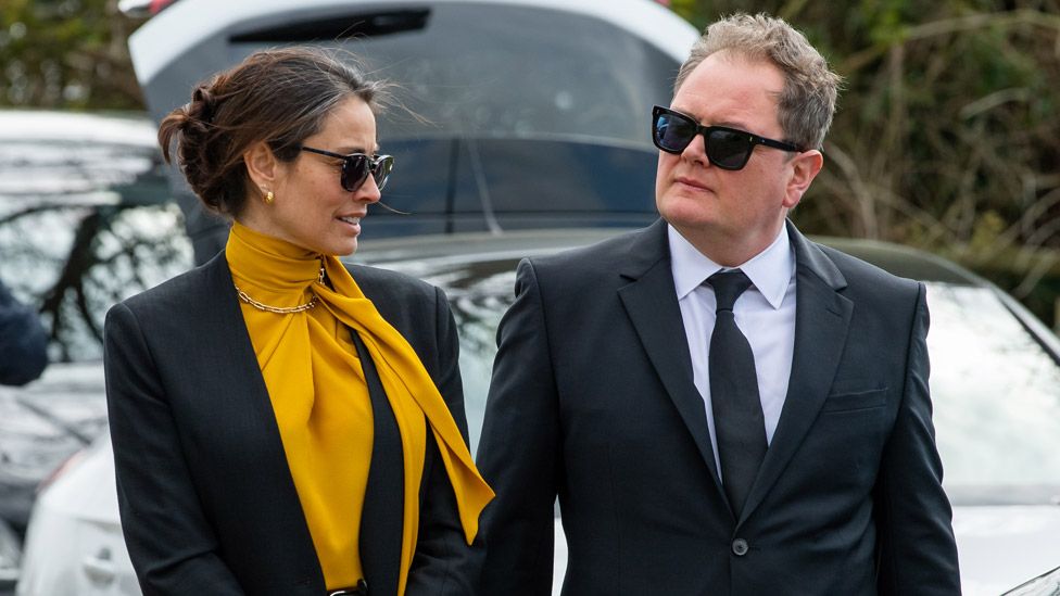 Melanie Sykes and Alan Carr attend the funeral of Paul O'Grady