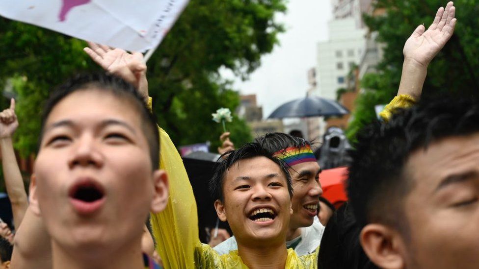 Gay rights supporters celebrate outside Parliament after lawmakers legalised same-sex marriage bill