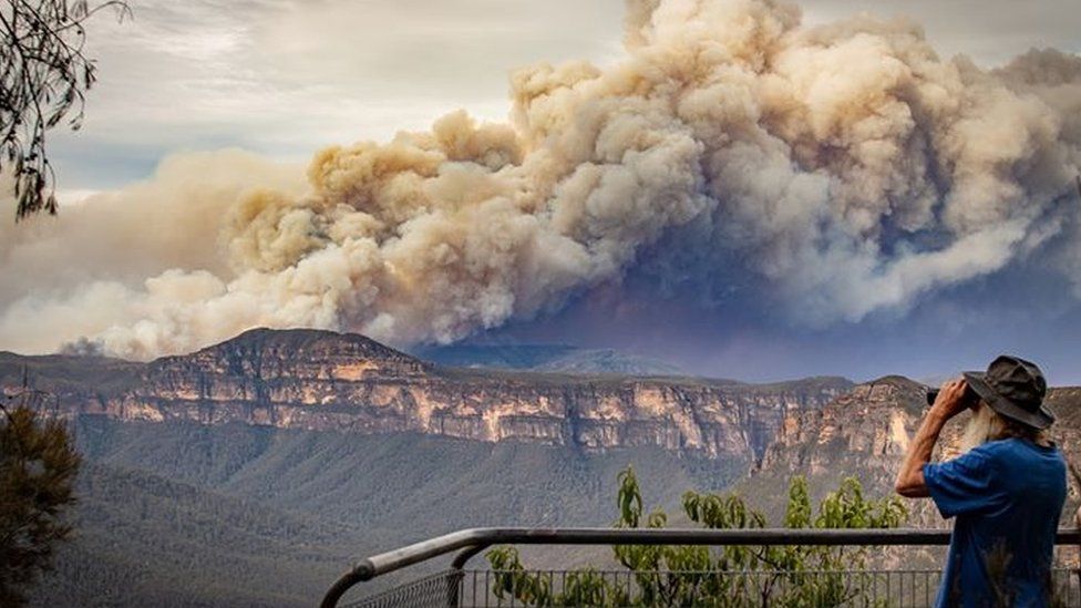 Huge plumes of smoke from a bushfire are seen at a lookout in the Blue Mountains west of Sydney