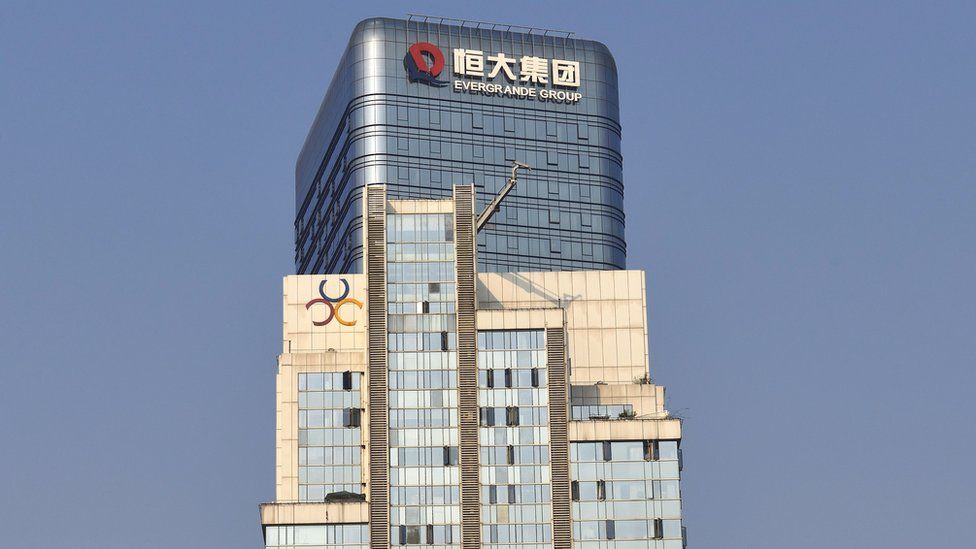 The logo of Evergrande Group is seen on the facade of a commercial building.