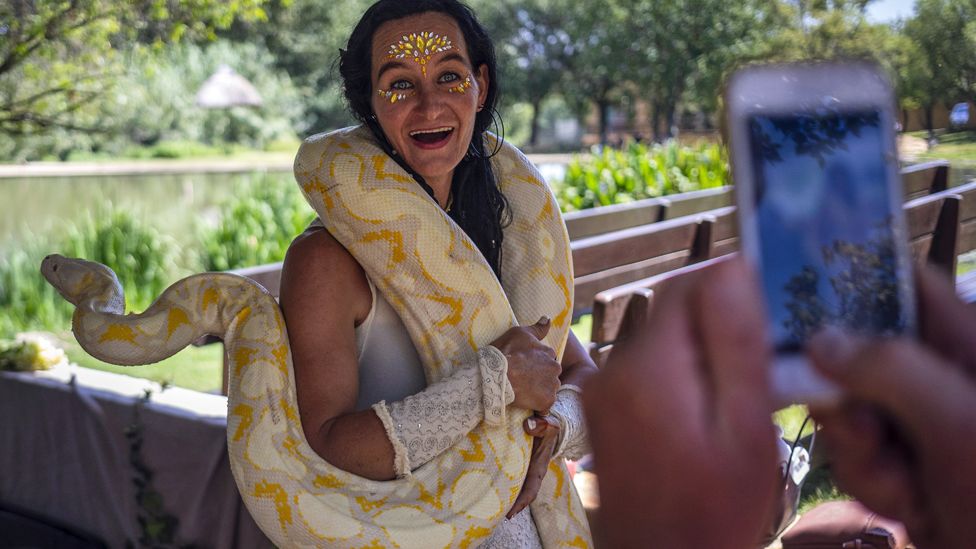 A woman posing with a python at the Medieval Fayre in Johannesburg, South Africa - Saturday 7 March 2020