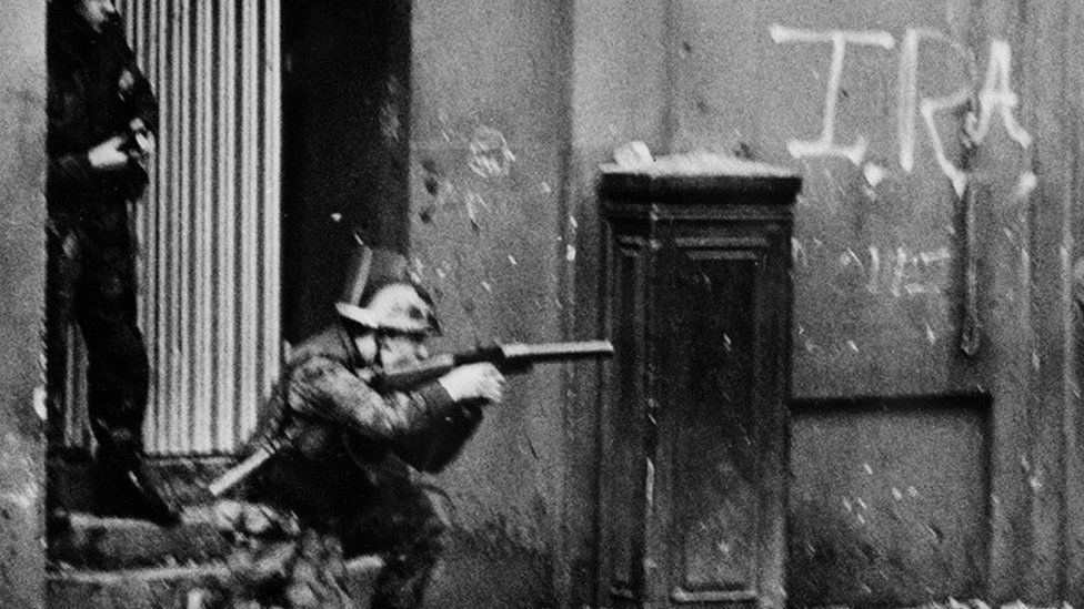 A soldier prepares to fire a plastic bullet on a street in Northern Ireland