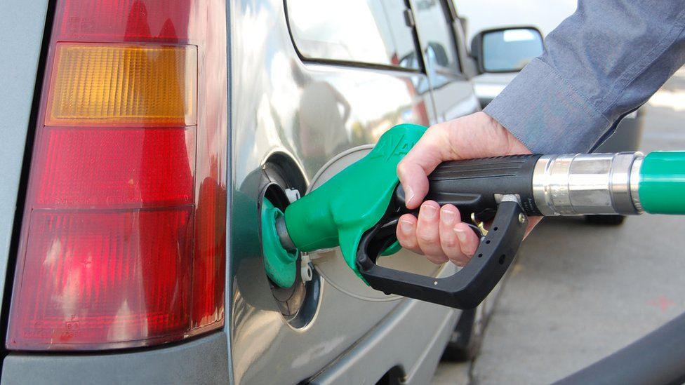 Man putting petrol into car