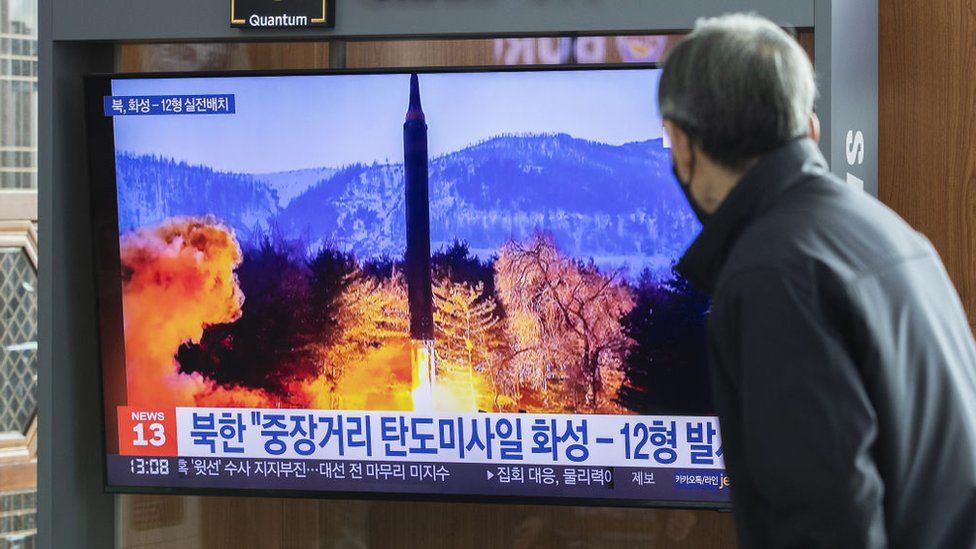 A North Korean man watches a state report on its latest missile tests