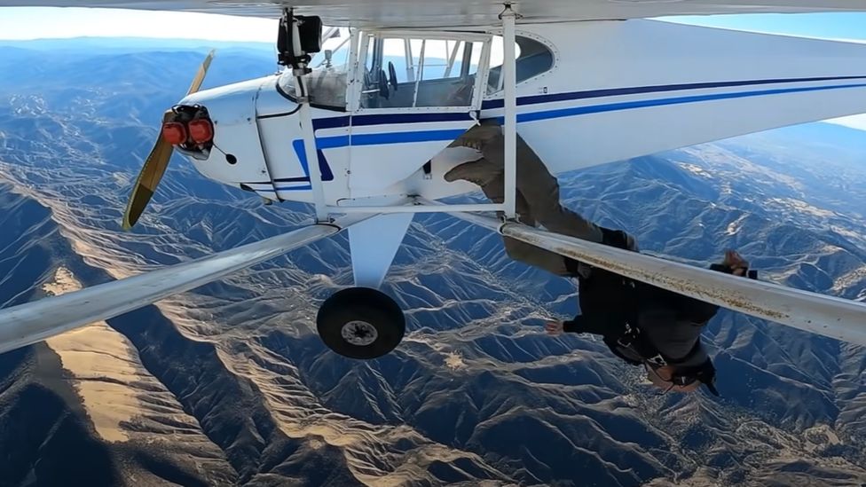 Trevor Jacob jumping headfirst out of his plane with the Los Padres mountains beneath him
