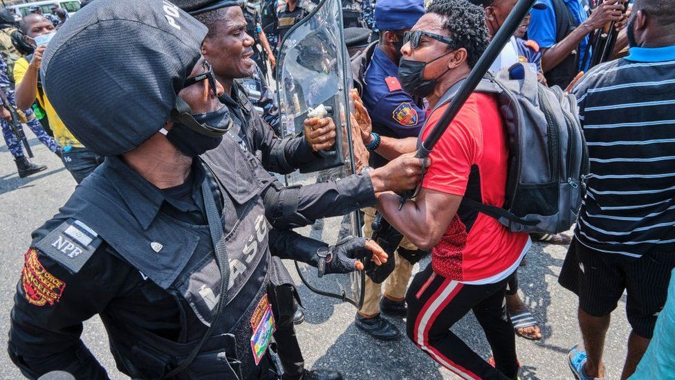 A policeman arresting a protestor during a demonstration against the re-opening of the Lekki toll plaza in Lagos