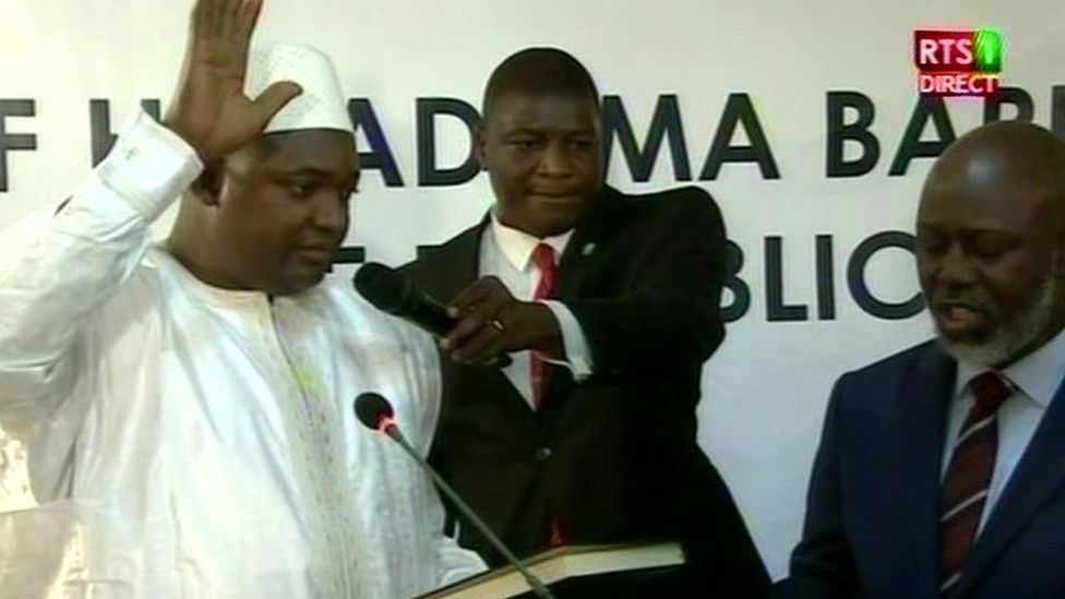 Adama Barrow (left) during his swearing in ceremony