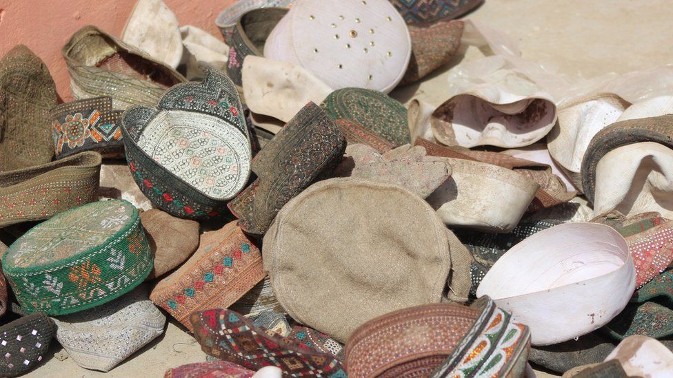 This photograph taken on April 4, 2018 shows caps that were said to belong to victims of an airstrike at a religious school in the Taliban-controlled Dasht-e Archi district in Kunduz province.