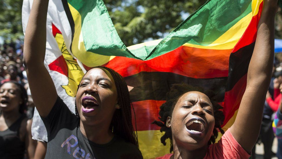 People holding Zimbabwean flag
