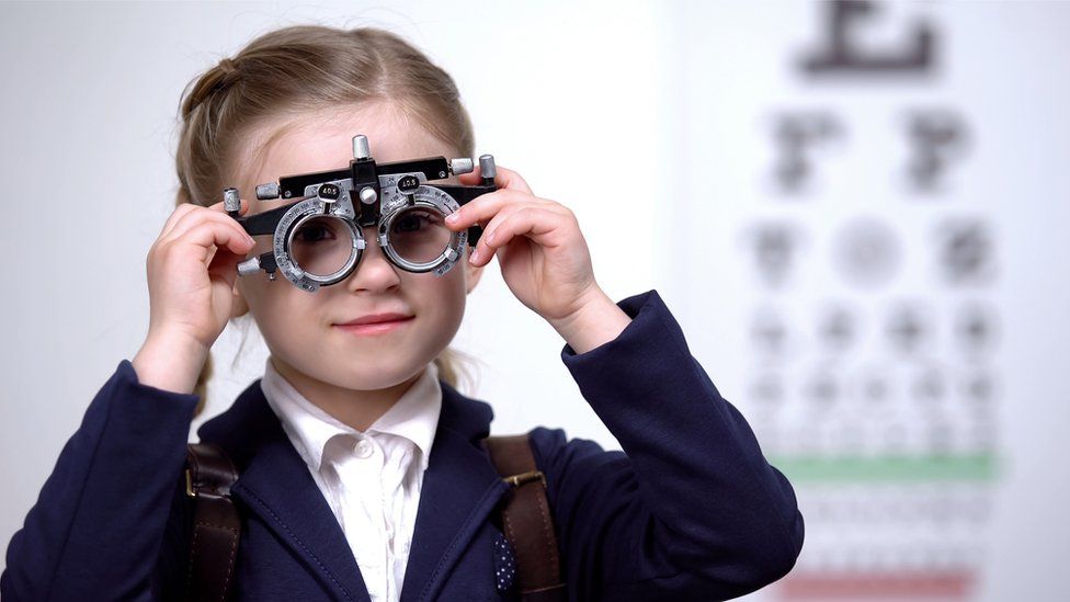A girl wearing eye testing kit