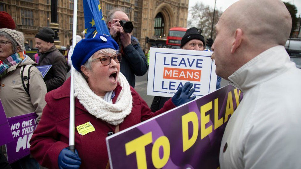 Pro- and anti-Brexit demonstrators argue outside Parliament in London
