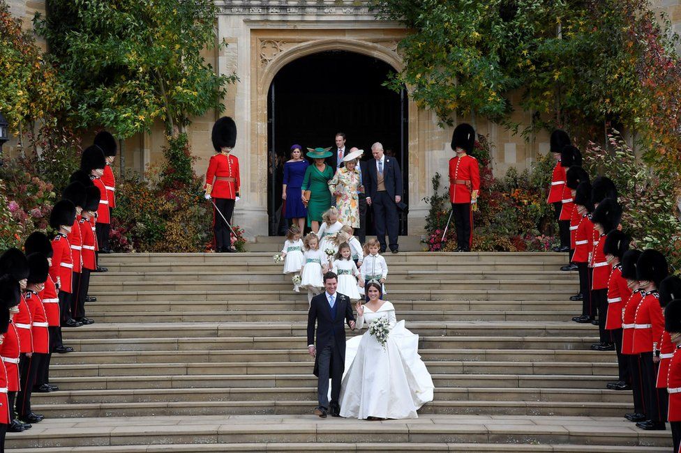 Princess Eugenie of York and her husband Jack Brooksbank walk down the West Steps of St Georg's Chapel