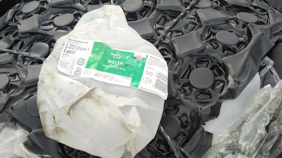Discarded plastic bottle with a "Welsh semi skimmed milk" label