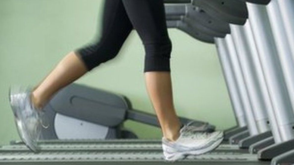 Woman running on treadmill in gym