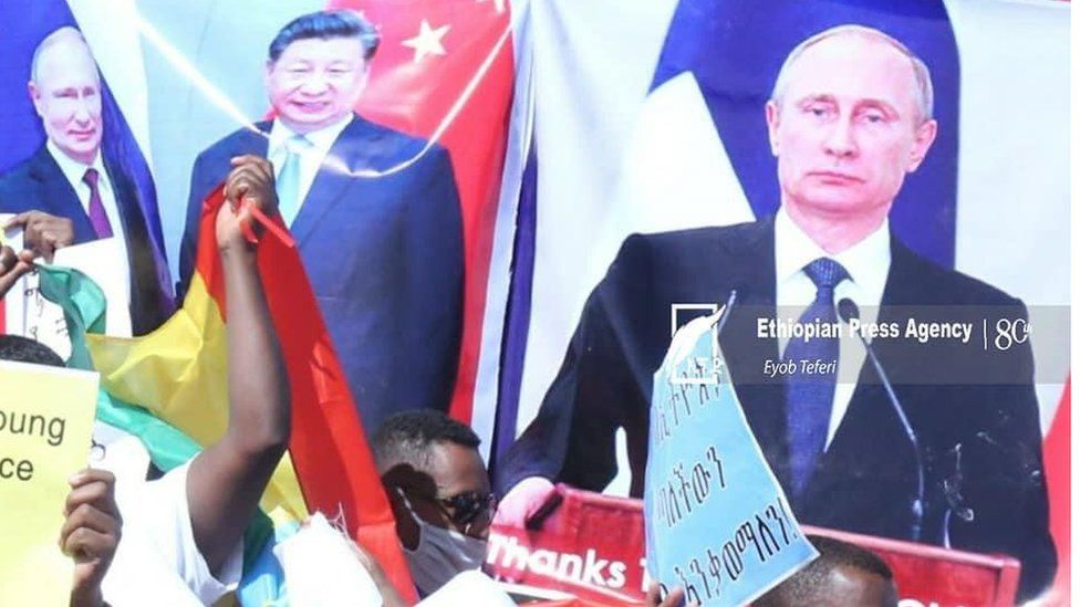 Some people held placards criticising Mr Biden while others applauded Russia's President Vladimir Putin and China's leader Xi Jinping.