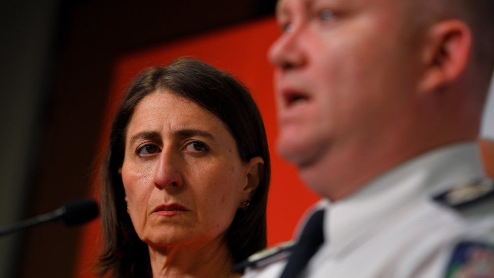 New South Wales Premier Gladys Berejiklian looks on as RFS Commissioner Shane Fitzsimmons speaks to the media during a press conference at Rural Fire Service (RFS) Headquarters in Sydney, Australia, 23 January 2020.